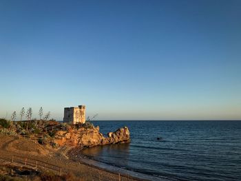 Scenic view of sea against clear blue sky