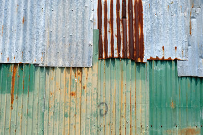 Rusty metal on wood against wall