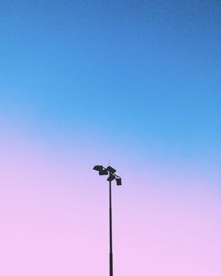 Low angle view of street light against clear blue sky