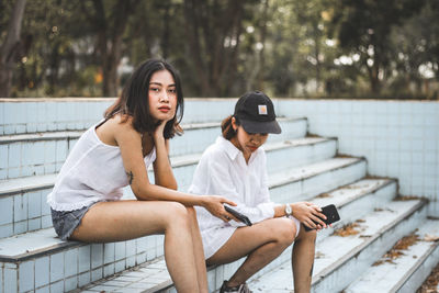 Young friends sitting on staircase