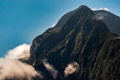 Cloud by mountain against sky