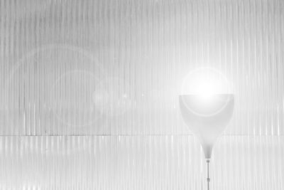 Close-up of illuminated lamp on table