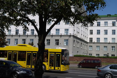 Cars on road against buildings in city