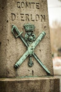 Close-up of text on metal at cemetery