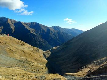 Scenic view of mountains against blue sky