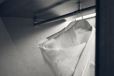 Close-up of clothes drying against white wall