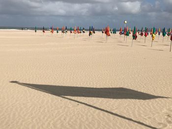 People on beach against sky