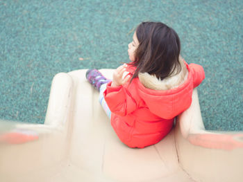 Rear view of woman sitting outdoors
