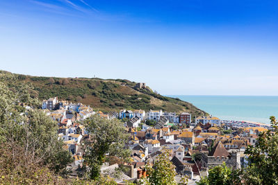 High angle view of townscape by sea against sky