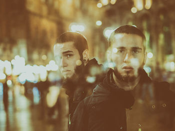 Multiple image of bearded young man on city street at night