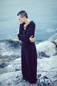 Woman standing on rock at beach