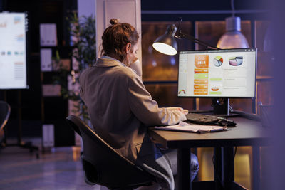 Woman using laptop at cafe