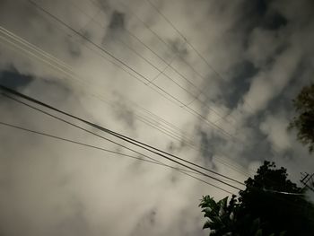 Low angle view of power lines against sky