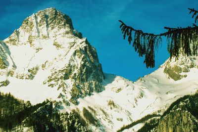 Low angle view of snowcapped mountains against sky