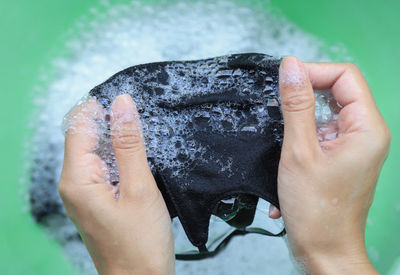 Close-up of person holding wet hand