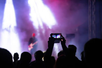 People photographing at music concert