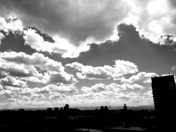 Low angle view of silhouette cityscape against sky