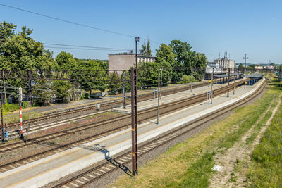 Railroad station platform against clear sky, train station in elblag, poland.