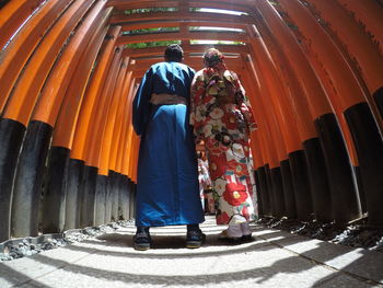 Rear view of people standing at temple