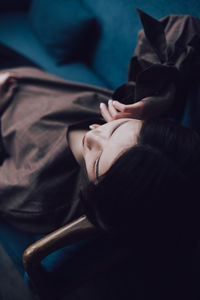 High angle view of woman relaxing on bed
