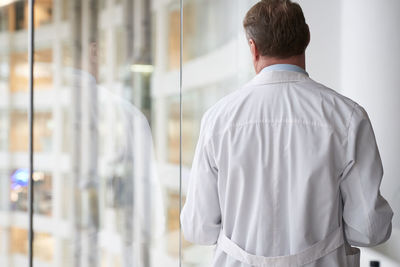 Rear view of man standing in city