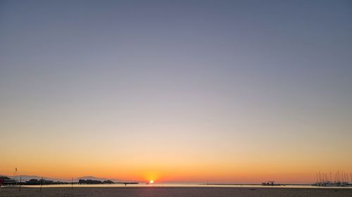 Scenic view of sea against clear sky during sunset