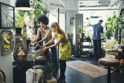 Male and female colleagues working in interior design shop