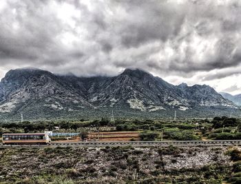 Scenic view of field and mountains against sky