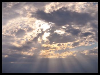 Low angle view of cloudy sky at sunset