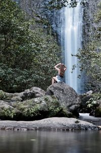 Young woman in swimming pool by lake