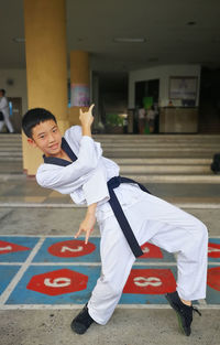 Portrait of boy standing on floor