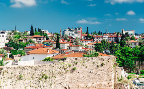 View of cityscape against cloudy sky