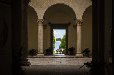 Rear view of man standing in historic building