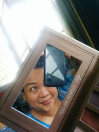 Close-up portrait of young woman using mobile phone