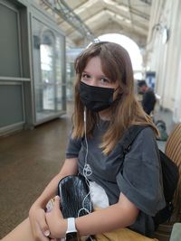 Portrait of a girl wearing a black protective mask