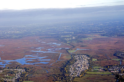 Aerial view of agricultural landscape against sky