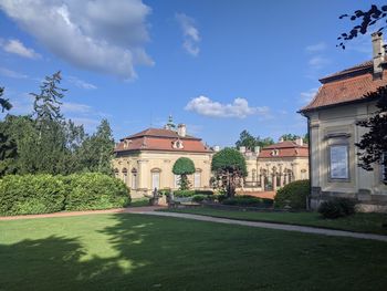 Lawn by building against sky