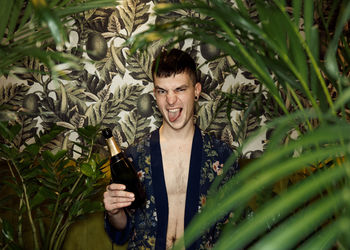 Portrait of young man against plants