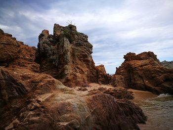 Low angle view of rock formations against sky