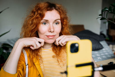 Young beauty blogger doing live streaming face massage on social media