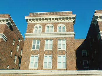 Low angle view of building against blue sky