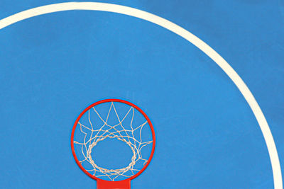 Low angle view of basketball hoop against blue sky