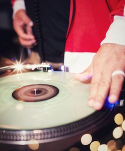 Midsection of man playing turntable