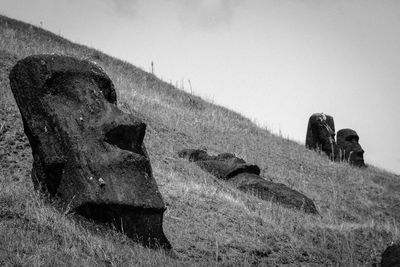 Moai statues at rapa nui against sky