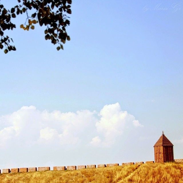 sky, built structure, architecture, building exterior, field, blue, rural scene, landscape, tranquil scene, tranquility, nature, copy space, beauty in nature, scenics, cloud, house, day, tree, low angle view, cloud - sky