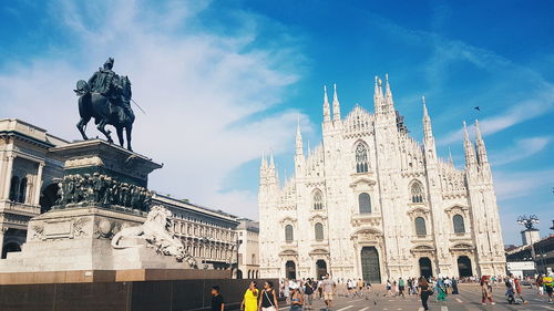 Statue in front of cathedral against sky