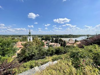 Panoramic view of trees and buildings against sky
