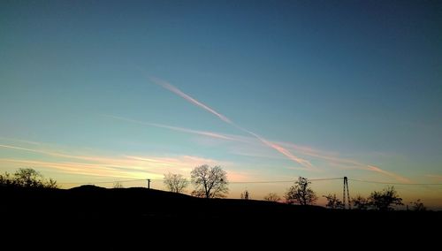 Silhouette landscape against sky during sunset