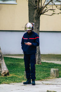 Portrait of man standing on footpath