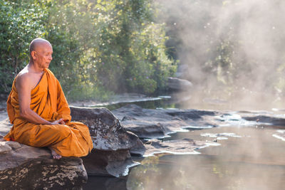 Senior buddhist monk by the water